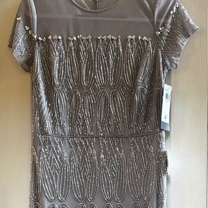 Silver beaded A-line gown by JS Collections.